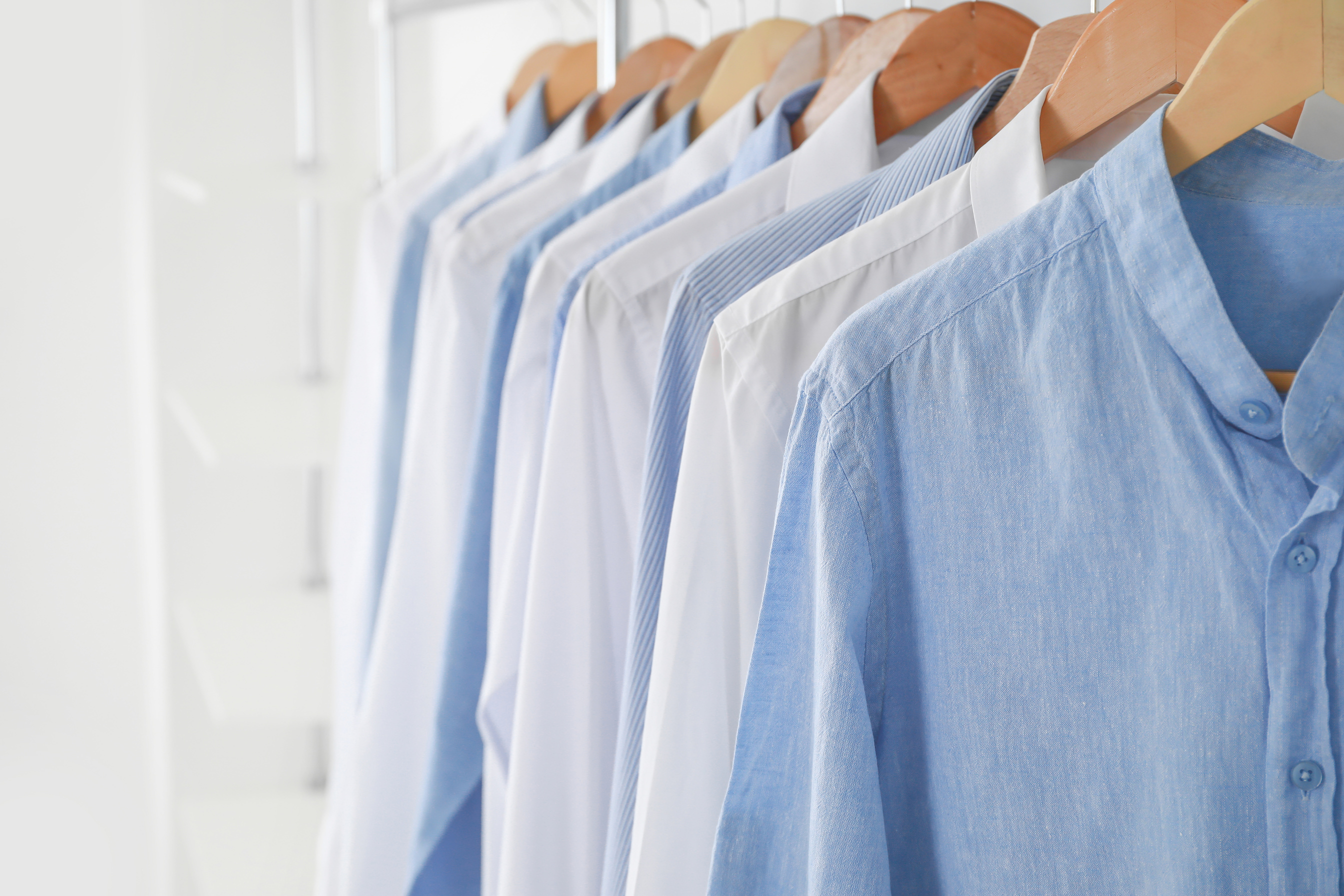 Rack with Clothes in Modern Dry-Cleaner's, Closeup