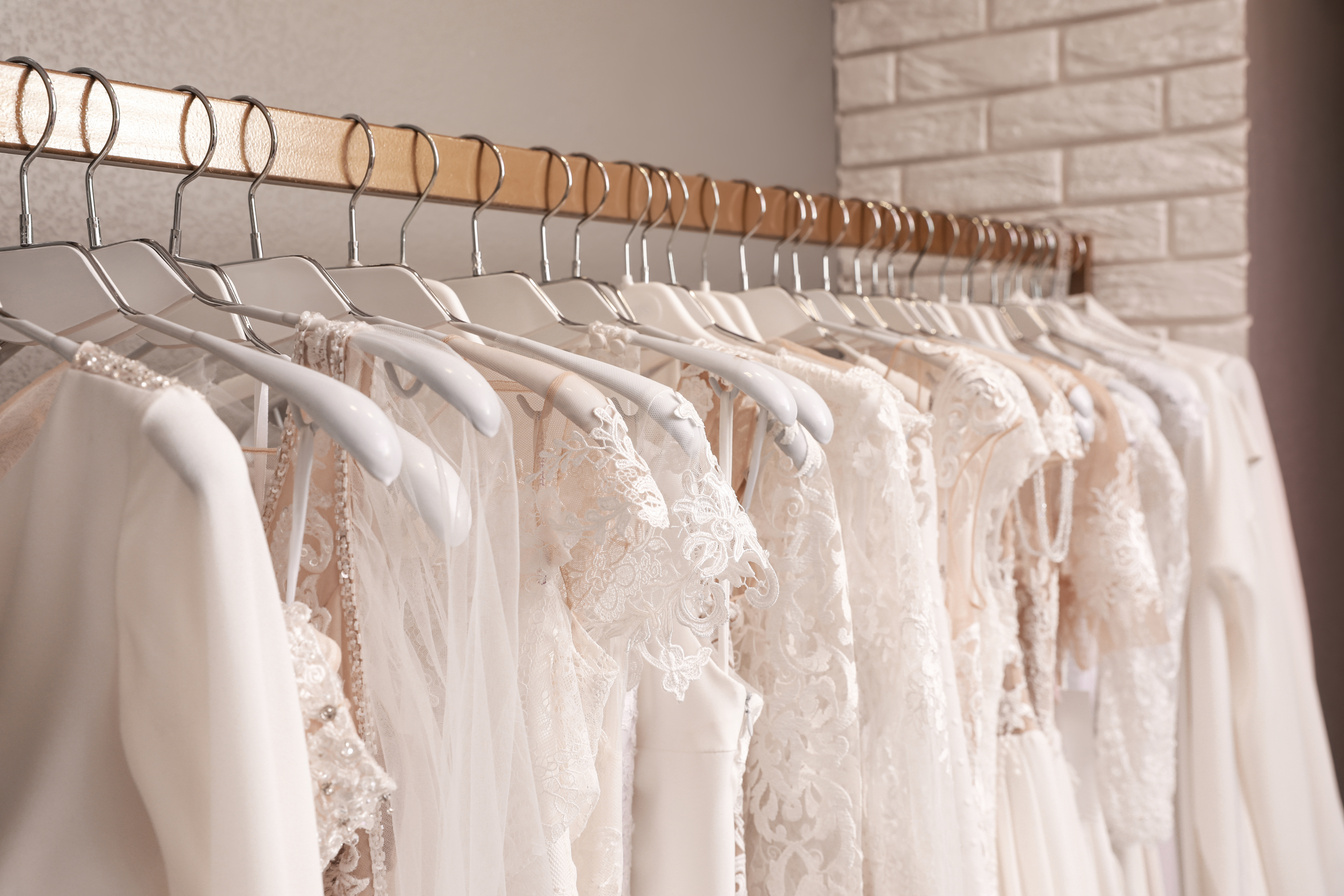 Different Wedding Dresses on Hangers in Boutique